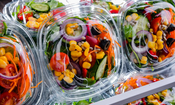 istock Boxes with pre-packaged vegetable salads in a commercial fridge 1490968202