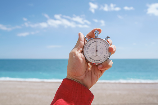 Close up of human hand holding a classic stopwatch