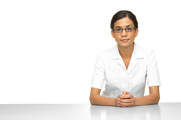 Woman wearing a white lab coat and glasses stock photo