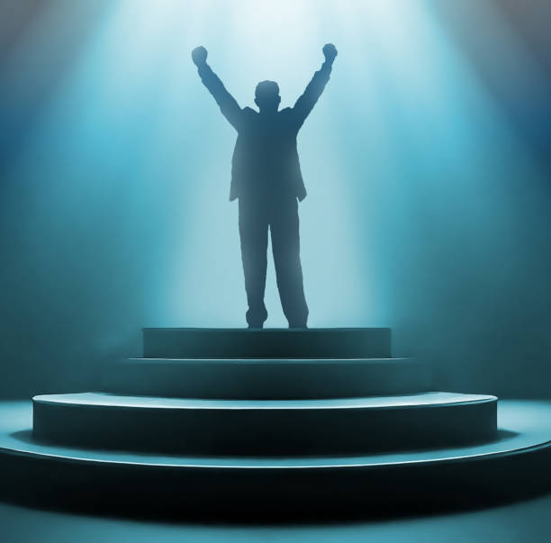 istock businessman standing on winner podium 1490969802