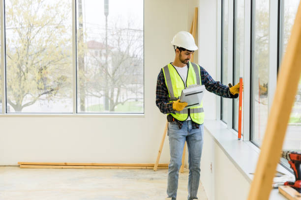 istock Male contractor uses a level to check the work that has been completed thus far 1490970003
