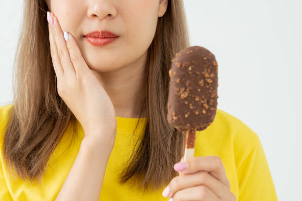 istock Asian woman feel sensitive teeth after eating ice cream, female suffer tooth, decay problems, dental care, tooth extraction, decay problem, bad breath, Gingival Recession, Oral Hygiene instruction 1490973419