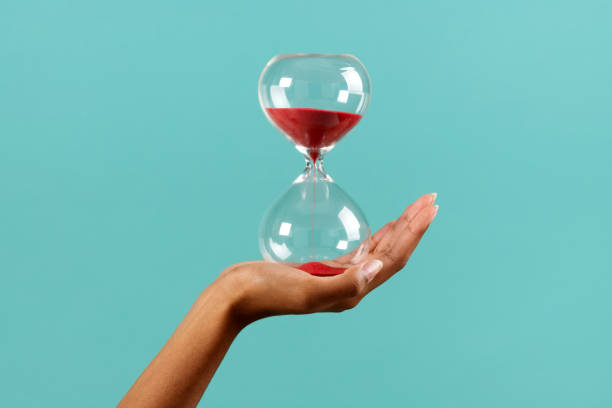 istock Crop black woman with red sand hourglass 1490974445