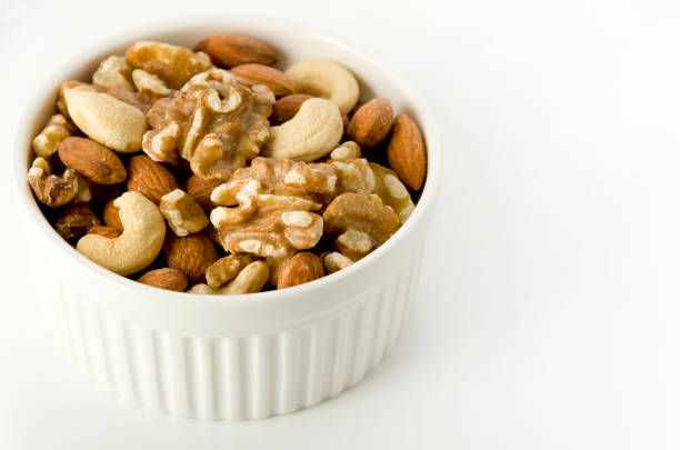 mix of nuts in a cocotte on a white background.