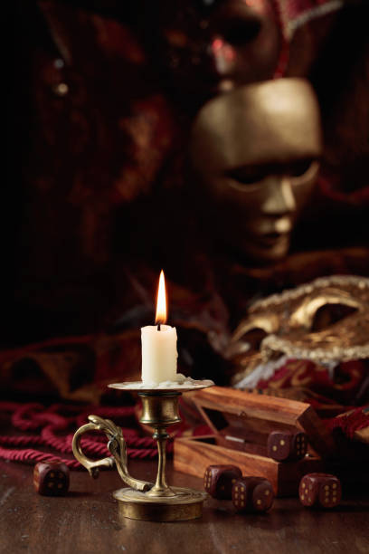 istock Burning candle, dice, and carnival masks. 1490975284