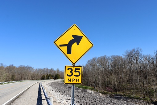 A close view of the yellow warning signs on the side of the road.