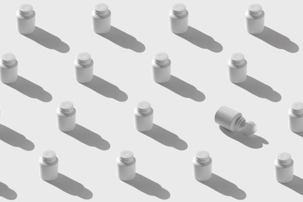 Minimal style pattern made of white plastic bottles for supplement, vitamin, pills on sunlit background with shadow. Set of containers packaging with a cap. Pharmacy and medicine concept