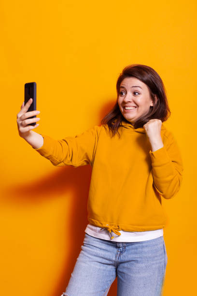 istock Positive adult looking at smartphone and smiling 1490978897