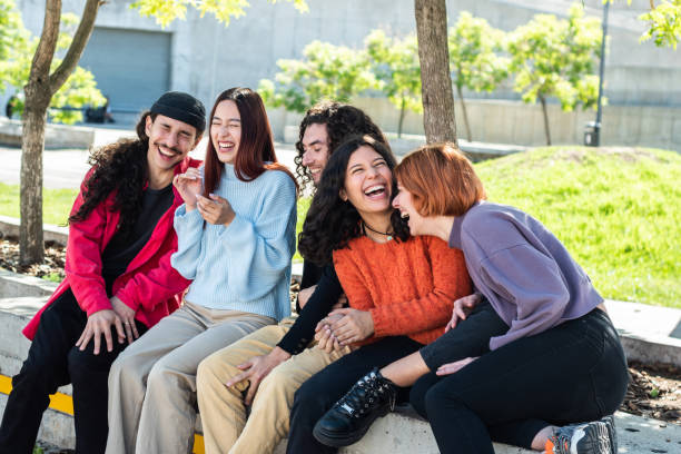 istock Young friends/students talking while having fun at street 1490980587
