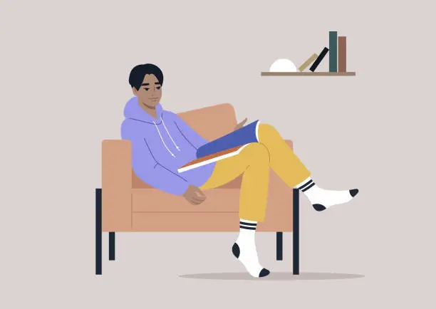 Vector illustration of A young male Asian character reading a magazine at home, comfortable armchair and a bookshelf