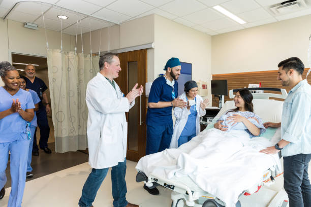 istock Diverse medical team celebrates with new mom after difficult delivery 1490982229