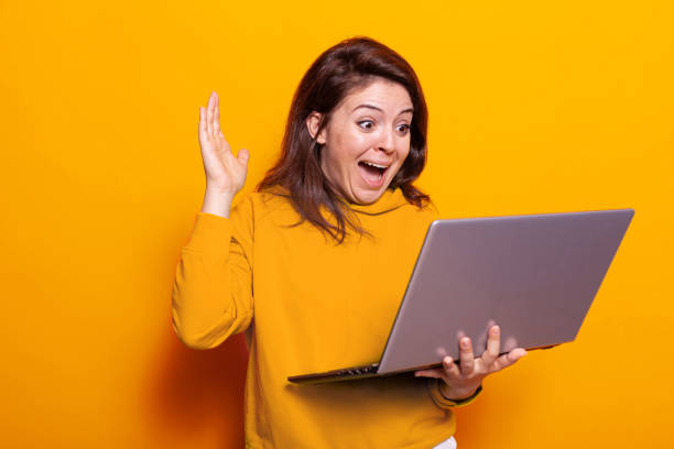 istock Smiling person waving hand at video call on laptop 1490982916