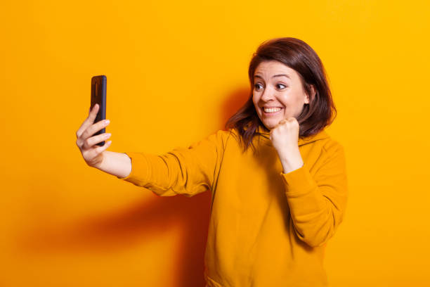 istock Caucasian woman looking at smartphone and smiling 1490983110