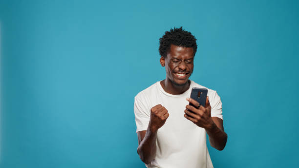 istock African american man feeling excited and using smartphone 1490984507