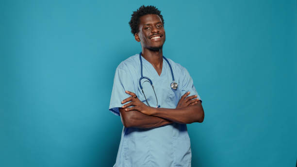 istock Positive nurse standing with crossed arms and smiling 1490985287