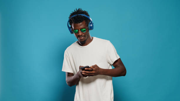 istock Person jumping and listening to music while using smartphone 1490985573