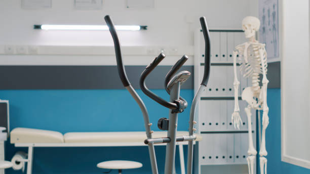 istock Empty medical office with stationary bicycle used at physical therapy 1490986350