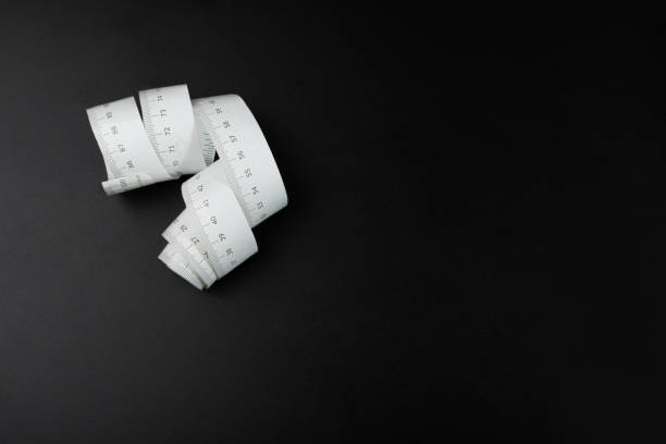 istock Measure Tapes Isolated, Metric Tape on Black Background 1490986402