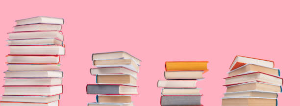 istock Composition with hardback books on wooden deck table and pink background. Books stacking. Back to school. Copy Space. Education background. panorama, banner. 1490986442