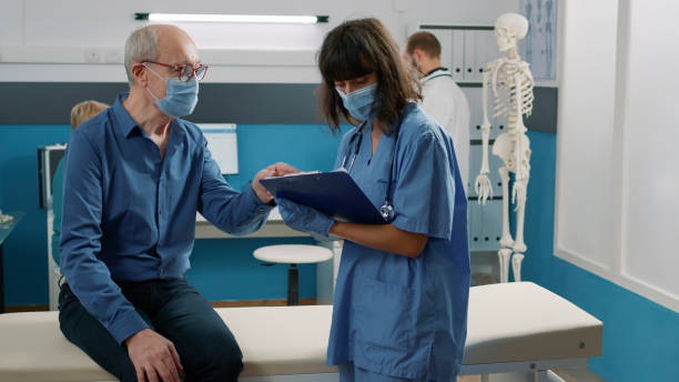 istock Female nurse taking notes at consultation appointment 1490988410