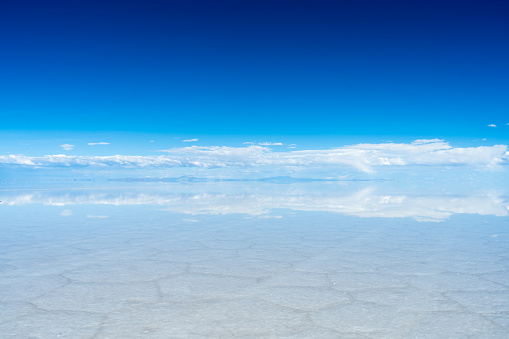 Uyuni Salt Flats. Altiplano, Bolivia. Rainy Season. Tunupa Volcano. Clouds Reflection on Water in Lake Surface