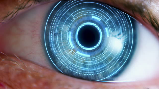 VFX Visualization: Macro Shot of Advanced Augmented Reality Technology Activated Inside Human Eye. Round Blue Interface Projection Spinning And Adjusting Around Iris And Pupil. Futuristic Concept.