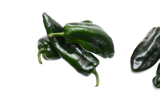 fresh green poblano peppers on white, top down