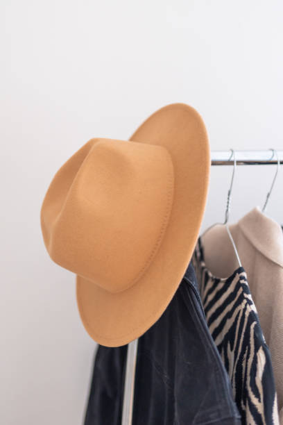istock Beige hat hangs on a clothing rack  in a store 1490992353