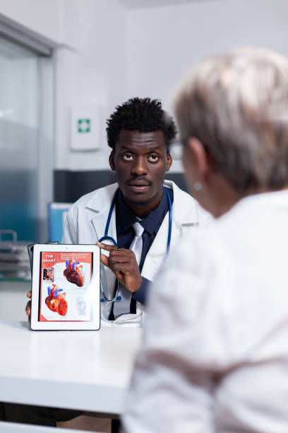 istock African american man with doctor occupation using tablet 1490994524