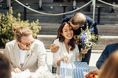 Friend kisses bride at wedding ceremony