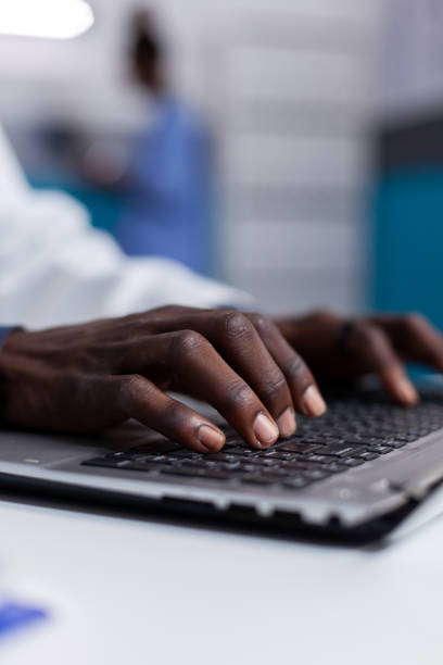 istock Close up of black hands typing on laptop keyboard 1490995250