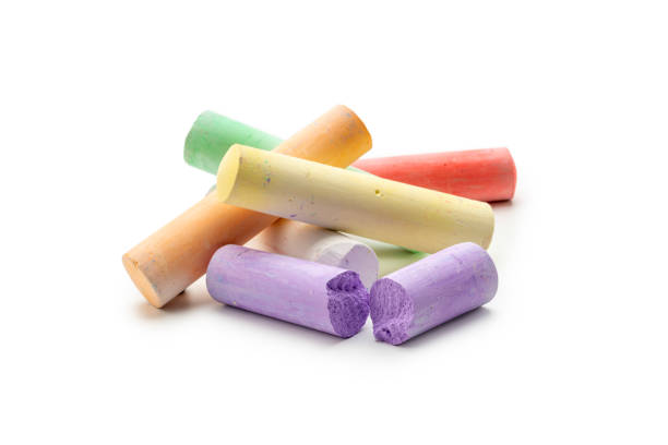 Concept kids: Pieces of colored chalk on a white background stock photo