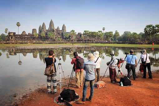 People visit Angkor Wat temple complex in Cambodia. The temples are listed as UNESCO World Heritage Site and date back to 12th century.