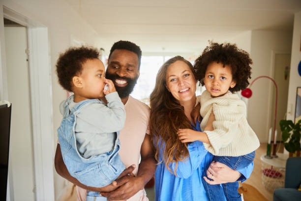 istock Smiling parents standing with their cute little sons at home 1491001624