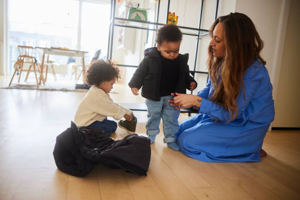 istock Mom dressing her little sons before going out for a walk 1491001921