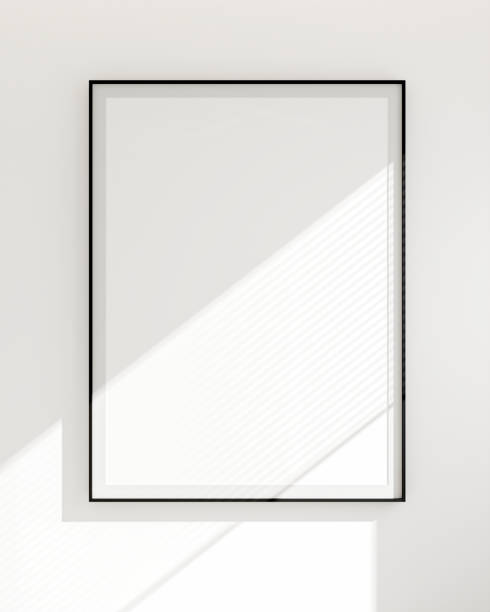 istock Blank white poster frame in black frame in white wall room, simple, elegant, modern. Sunlight shines from the window. Background template. 3D rendering 1491001950