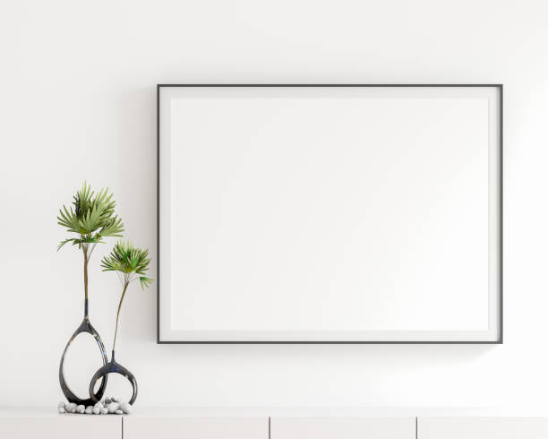 istock Blank white poster frame, black frame in the livingroom, elegant simple white wall, modern display cabinet, table top, white book, black vase, green leaf bouquet, decorative stones. 3D rendering 1491001972