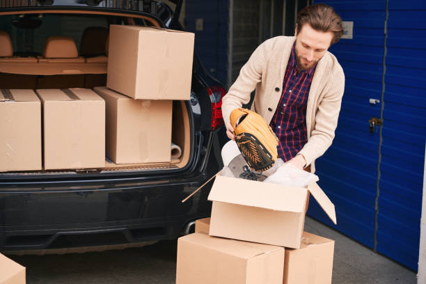 istock Young guy is packing his things in cardboard boxes in the warehouse 1491007037
