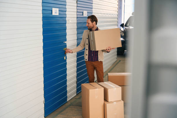istock Young man with big cardboard boxes in self storage unit 1491007258