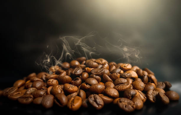 Brown roasted hot coffee beans on dark background