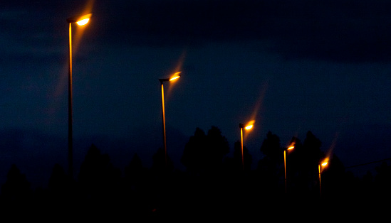 Road view at night, straight row of street lights. Galicia, Spain