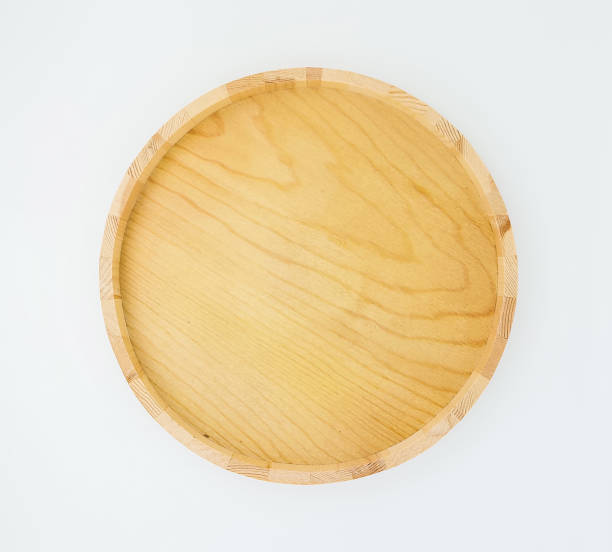 istock One empty round wooden tray, isolated on white background with copy space. Top view or flat lay. 1491010683