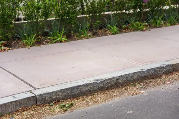 Photo of Sidewalk symbolizes pedestrian movement, urban life, and community. It represents a safe space for walking, social interactions, and the integration of people within a cityscape