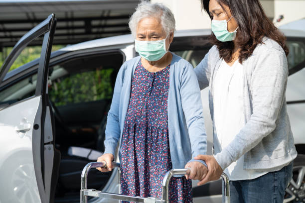 Asian senior woman patient sitting on walker prepare get to her car, healthy strong medical concept. Asian senior woman patient sitting on walker prepare get to her car, healthy strong medical concept. senior adult car nurse physical impairment stock pictures, royalty-free photos & images