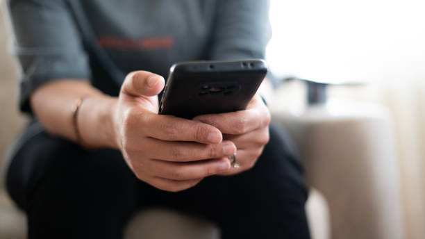 istock Close-up Woman hand using phone at home 1491020656