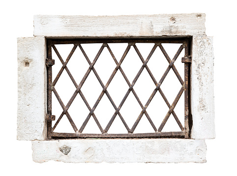 front view closeup of vintage window with stone marble frame protected with metallic railing bars isolated on white