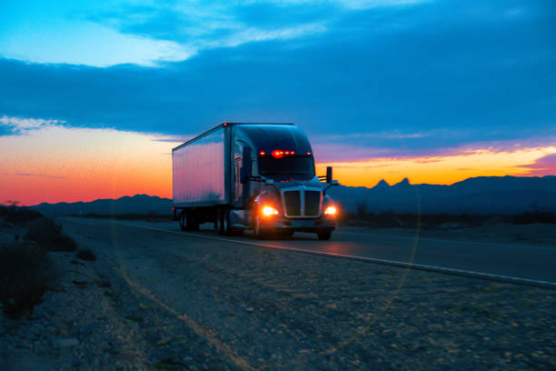 istock At sunset, an 18-wheeler rumbled through the Nevada desert, its massive form cutting through the golden hues. The majestic mountains stood as silent witnesses against the vibrant sky, creating a scene of desert grandeur. 1491023243