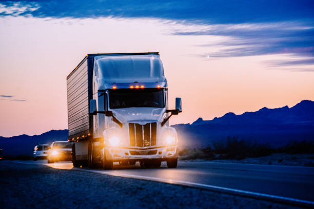 istock A white semi truck drove through the Nevada Desert, its massive form cutting through the vast expanse. The mountains stood tall in the background, bathed in the warm hues of a breathtaking sunset. 1491023662