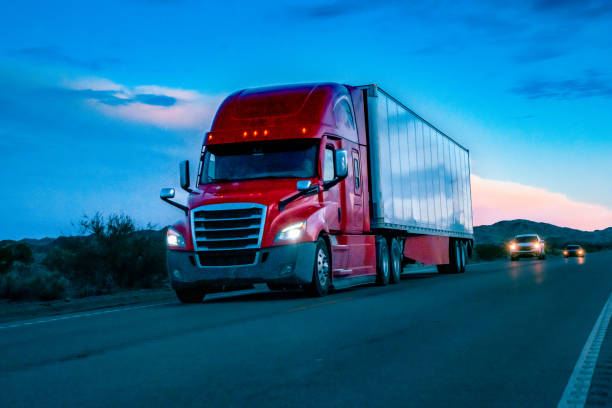 istock At sunset, a mighty semi truck rolled through the Nevada desert, its massive frame cutting through the open expanse. The mountains formed a majestic backdrop, painted in the warm hues of dusk. 1491023913