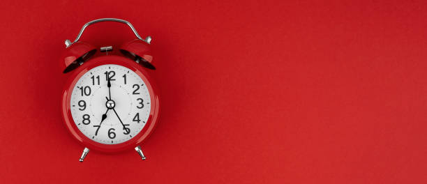 istock Red alarm clock on a red background. Top view. 1491027038